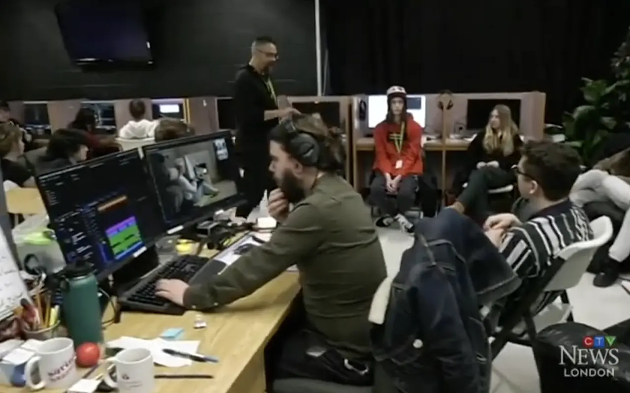 DCAC crew collaborating on a project, using multiple computer monitors.