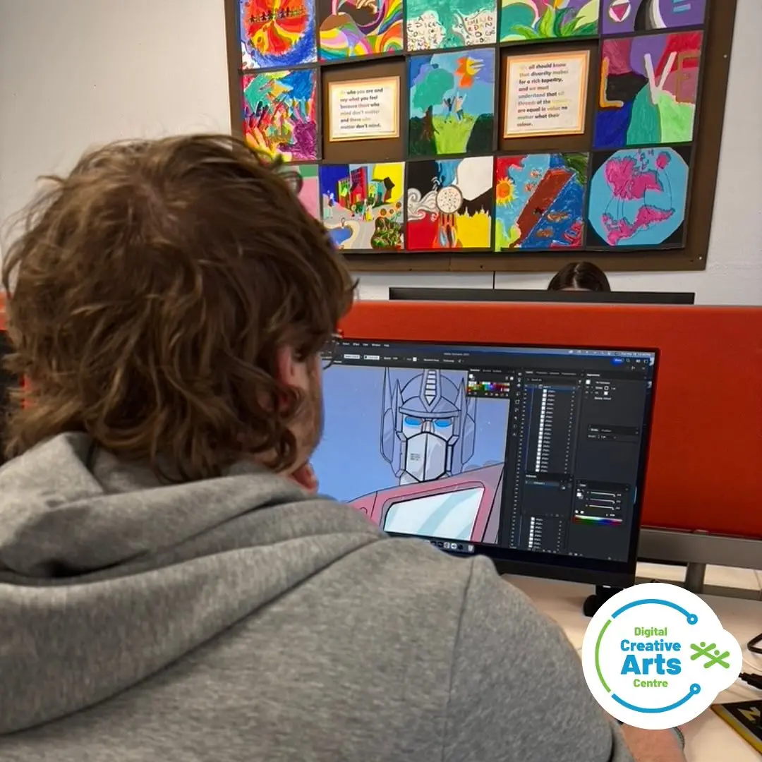 Student digitally drawing Optimus Prime on a computer at Digital Creative Arts Centre.