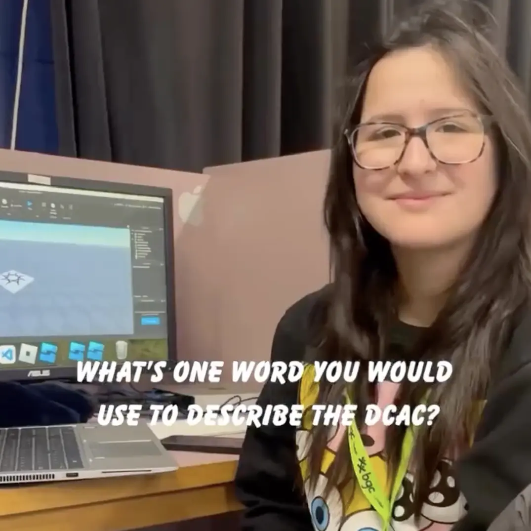 Young woman at desk, using design software, asked to describe DCAC in one word.