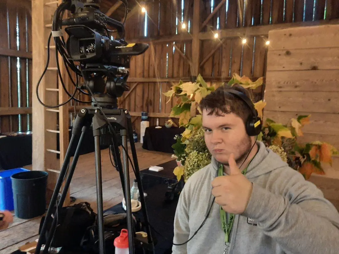Videographer giving thumbs up at SHSM workshop in rustic barn