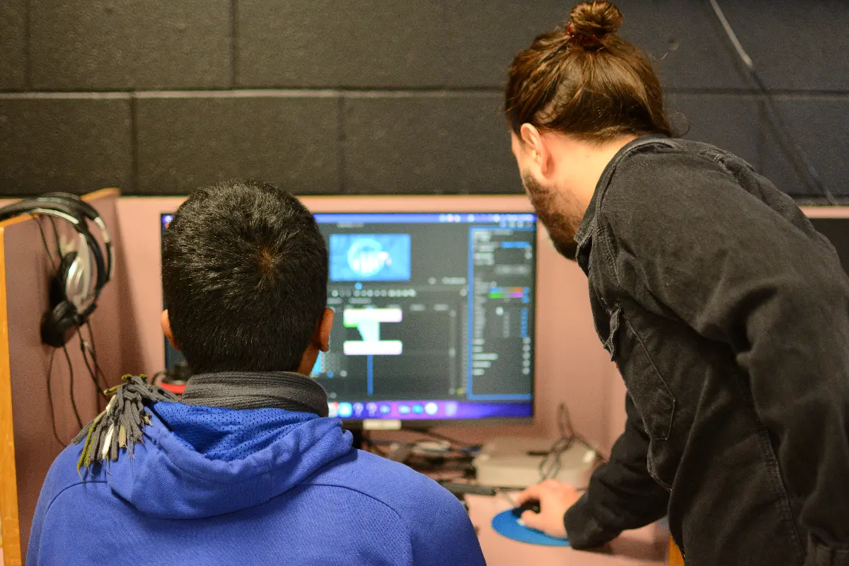 Two students collaborate on a computer during a hands-on SHSM workshop.